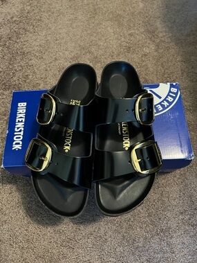Birkenstock Arizona Two-Strap Sandals in Gloss Black with Gold Buckles